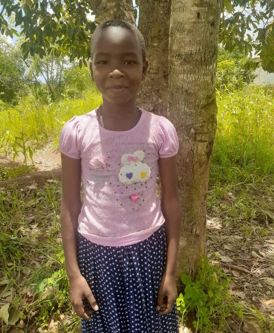 Click Magreth's picture to sponsor her - She is 11 years old, loves math, and wants to be a nurse.