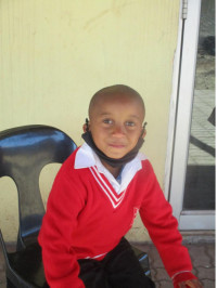 Click Thabo's picture to sponsor him - He is 8 years old, enjoys learning to write, and wants to be a policeman.